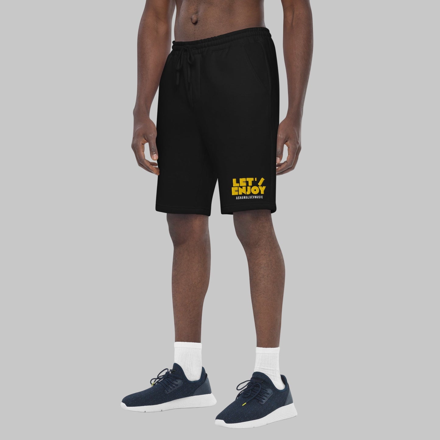 Black shorts with yellow text 'Let's Enjoy' on a grey background