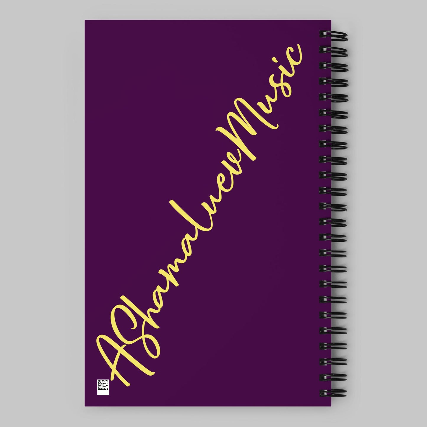 Purple notebook with 'AShamaluevMusic' text on a gray background