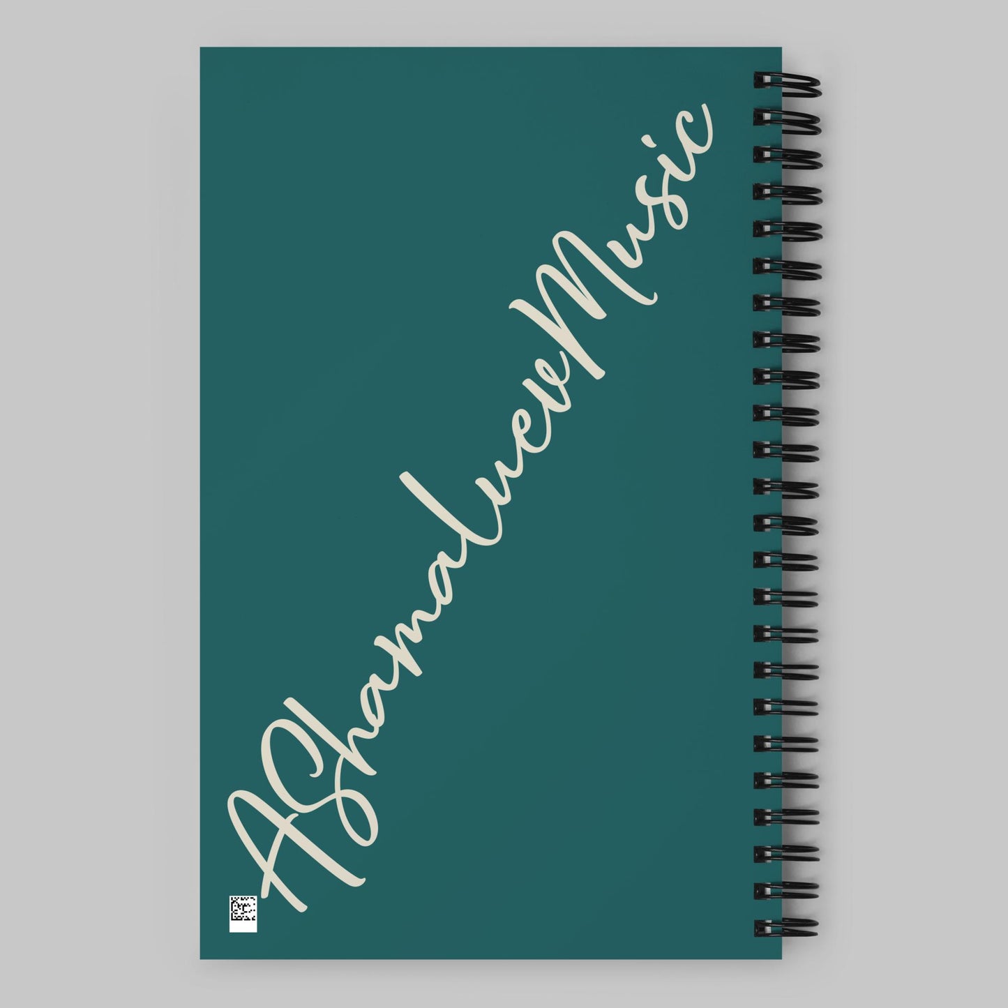 Green notebook with 'AShameluevMusic' text on a gray background