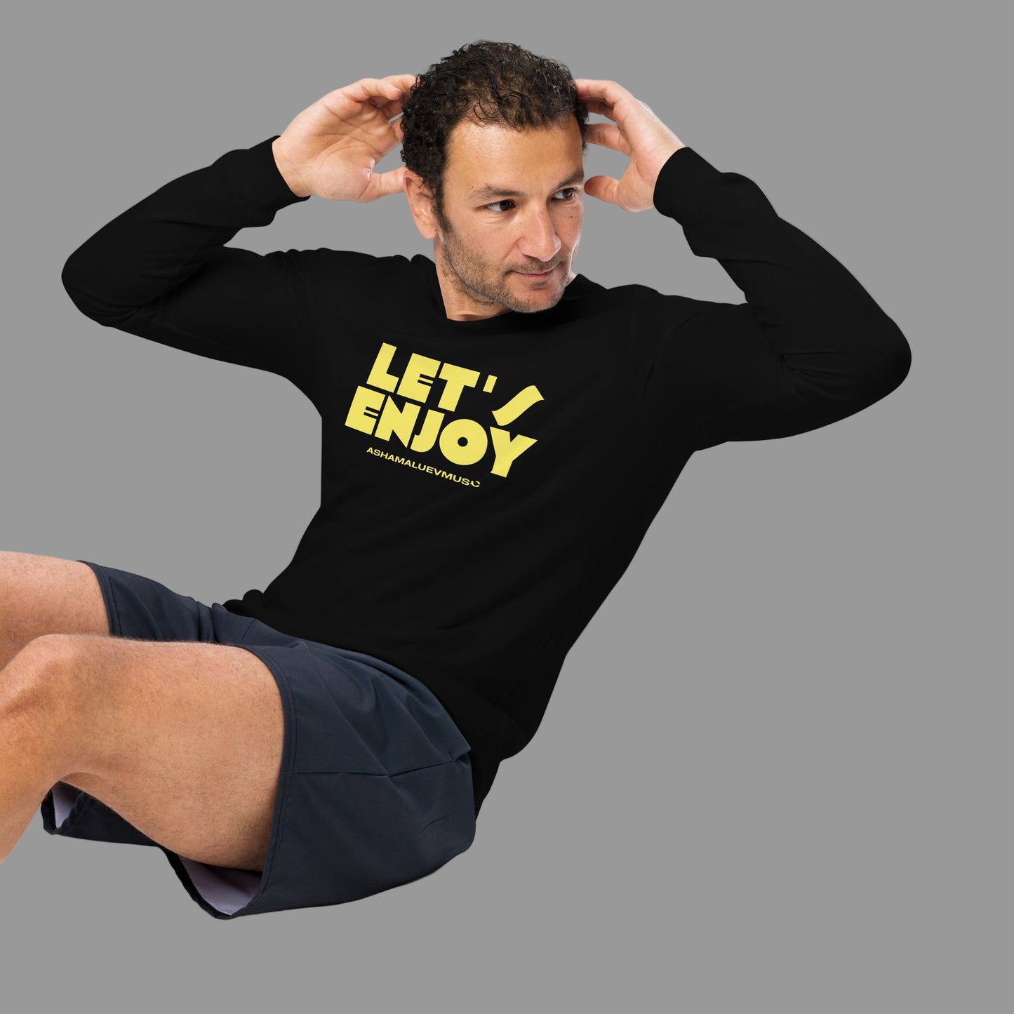 Man wearing a black sweatshirt with 'LET'S ENJOY' text on a grey background