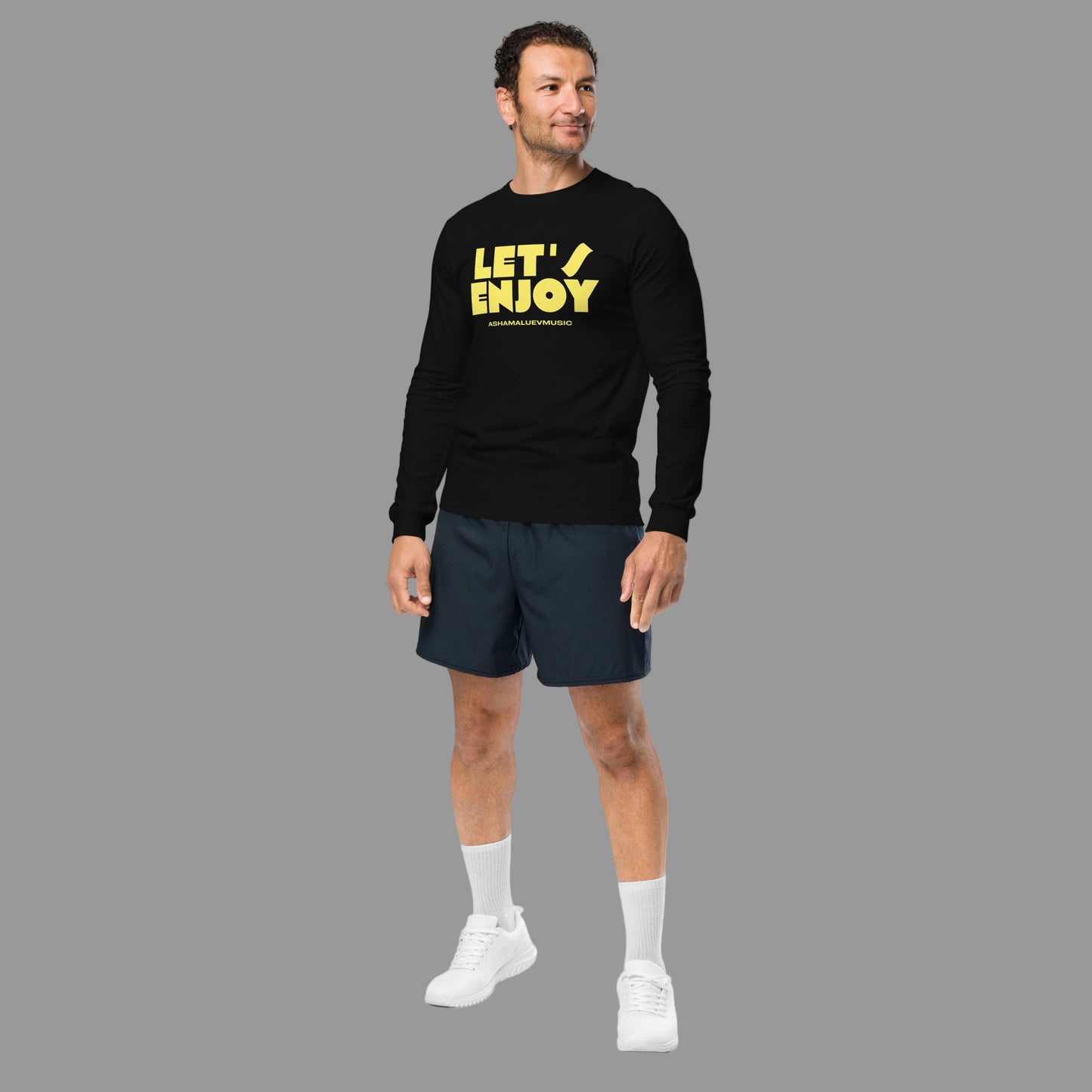 Man wearing a black sweatshirt with 'LET'S ENJOY' text and navy shorts on a grey background