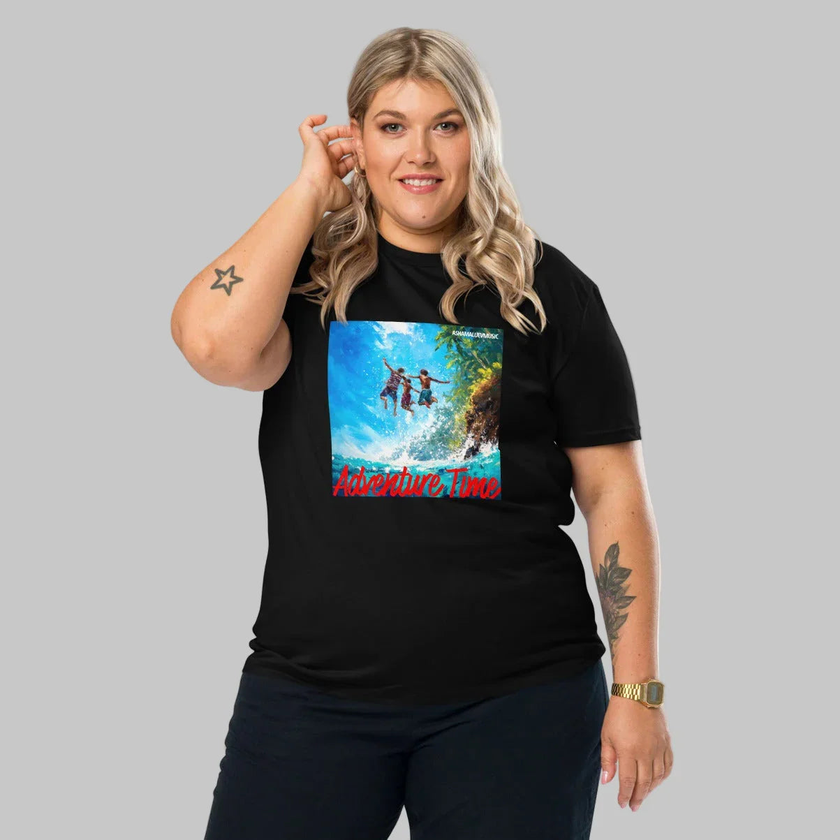 Woman wearing a black t-shirt with a 'Adventure Time' graphic design and AShamaluevMusic logo on a grey background.