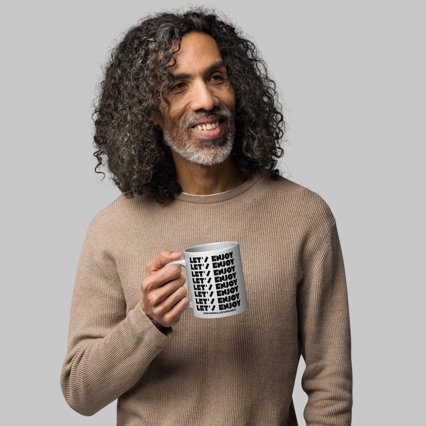 Man holding a mug with text 'Let's Enjoy' and 'AShamaluevMusic' on a white background
