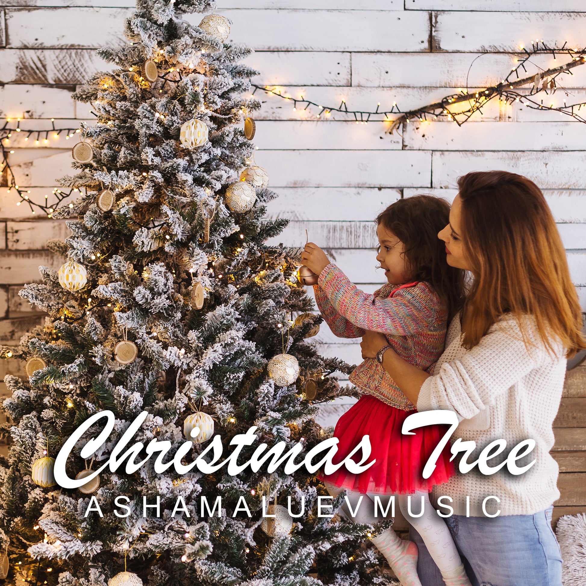 Cover art of the music track 'Christmas Tree' by AShamaluevMusic, which shows the woman and child decorating a Christmas tree with lights and ornaments against a wooden wall.