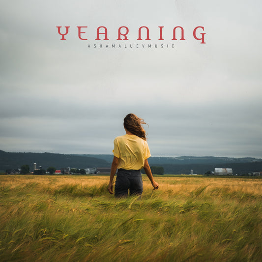 Cover art of the music track 'Yearning' by AShamaluevMusic, which shows the person standing in a field.