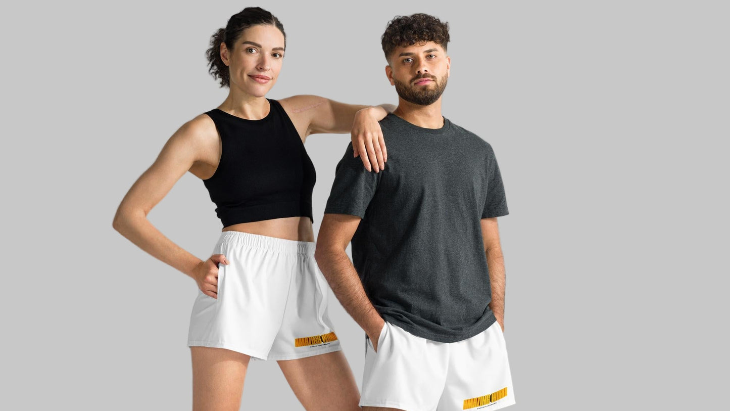 Two people wearing matching white athletic shorts with print 'Amazing World' and 'AShamaluevMusic' logo a gray background