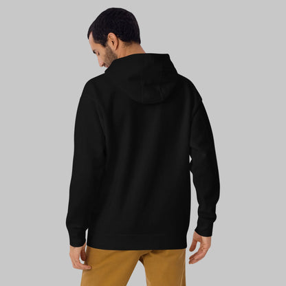 Man wearing a black hoodie from behind on a gray background