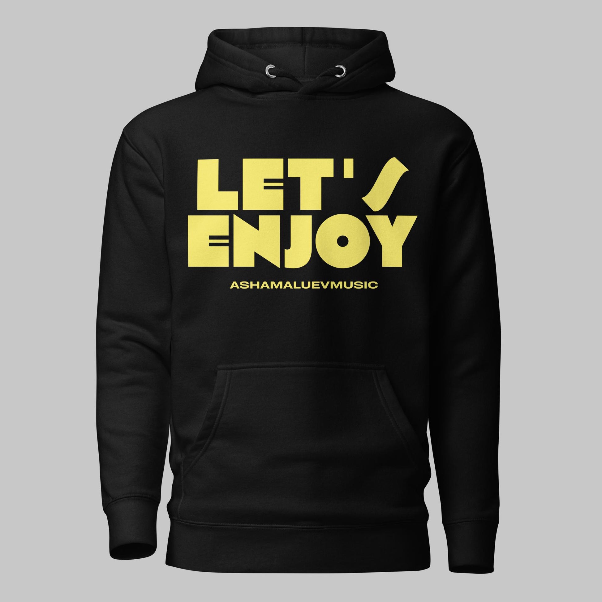 Black unisex pullover hoodie with yellow text 'LET'S ENJOY' and 'ASHAMALUEVMUSIC' on a gray background