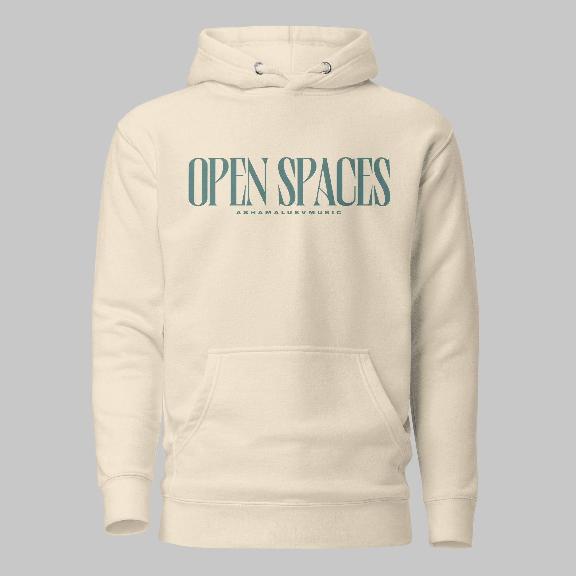Bone unisex premium hoodie with turquoise text 'Open Spaces' and 'AShamaluevMusic' on a gray background