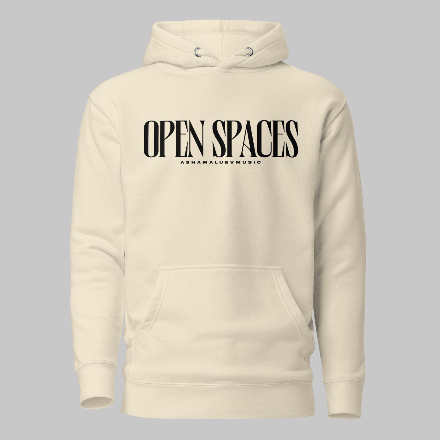 Bone unisex pullover premium hoodie with black text 'OPEN SPACES' and 'AShamaluevMusic' on a gray background.