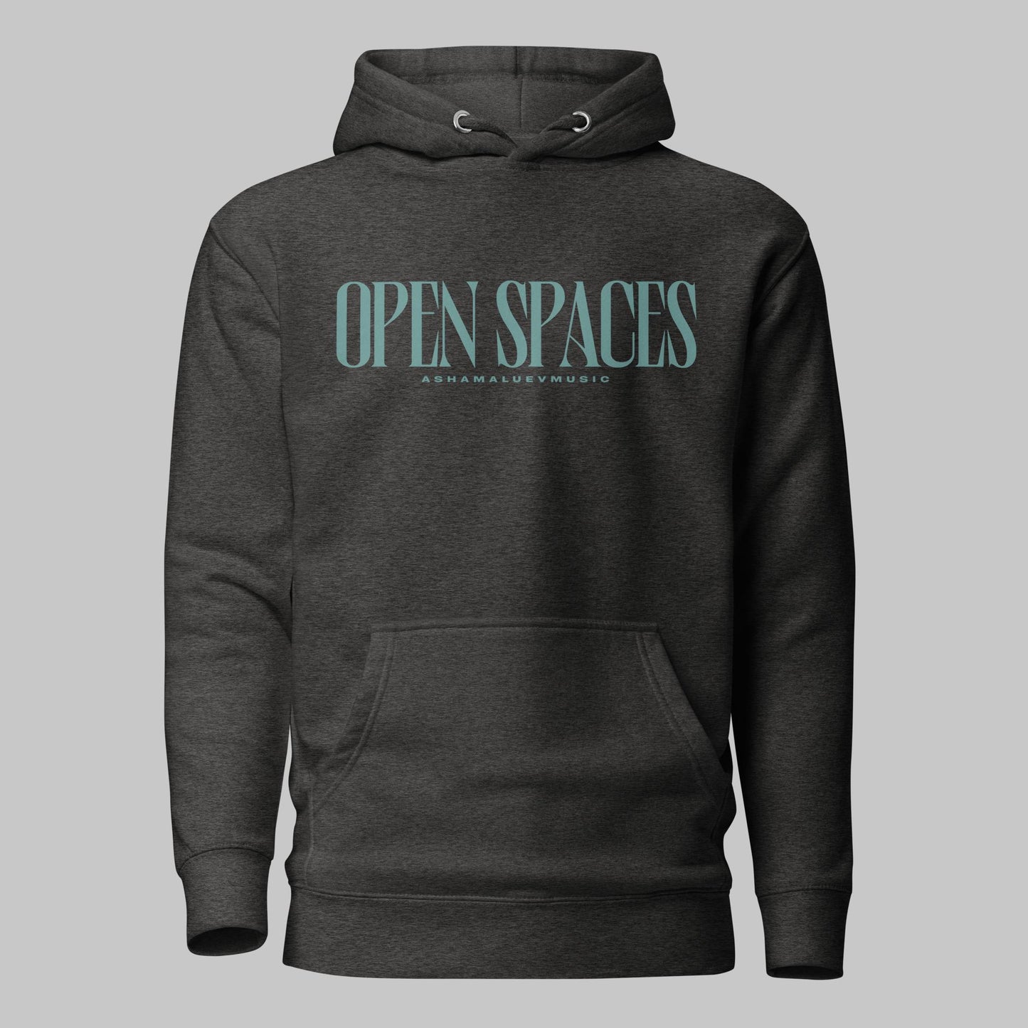 Charcoal heather unisex premium hoodie with turquoise text 'Open Spaces' and 'AShamaluevMusic' on a gray background