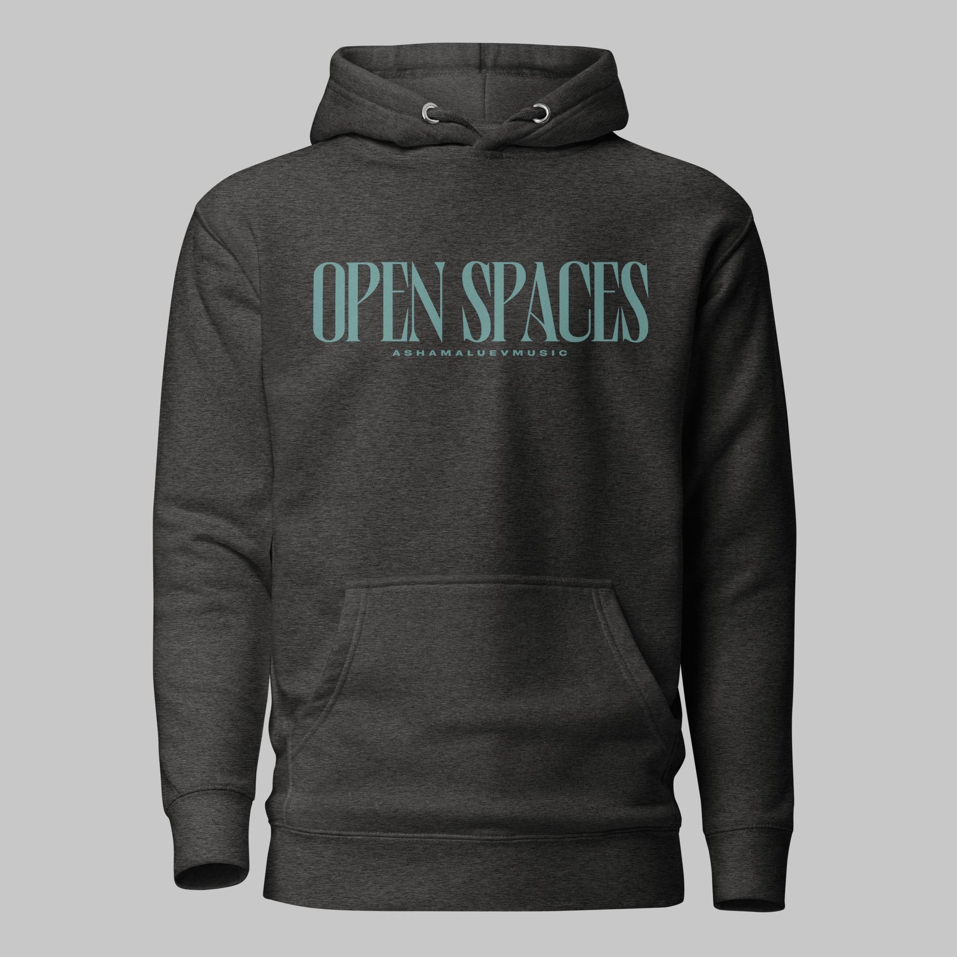 Charcoal heather unisex premium hoodie with turquoise text 'Open Spaces' and 'AShamaluevMusic' on a gray background