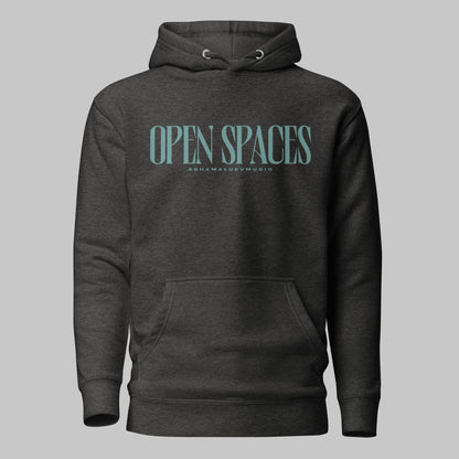 Charcoal heather unisex premium hoodie with turquoise text 'Open Spaces' and 'AShamaluevMusic' on a gray background