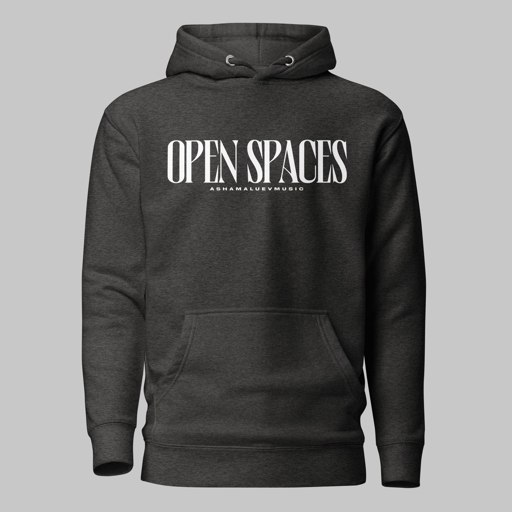 Charcoal heather unisex pullover premium hoodie with white text 'OPEN SPACES' and 'AShamaluevMusic' on a gray background.