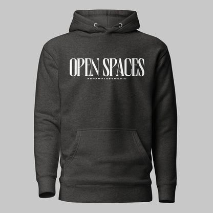 Charcoal heather unisex pullover premium hoodie with white text 'OPEN SPACES' and 'AShamaluevMusic' on a gray background.