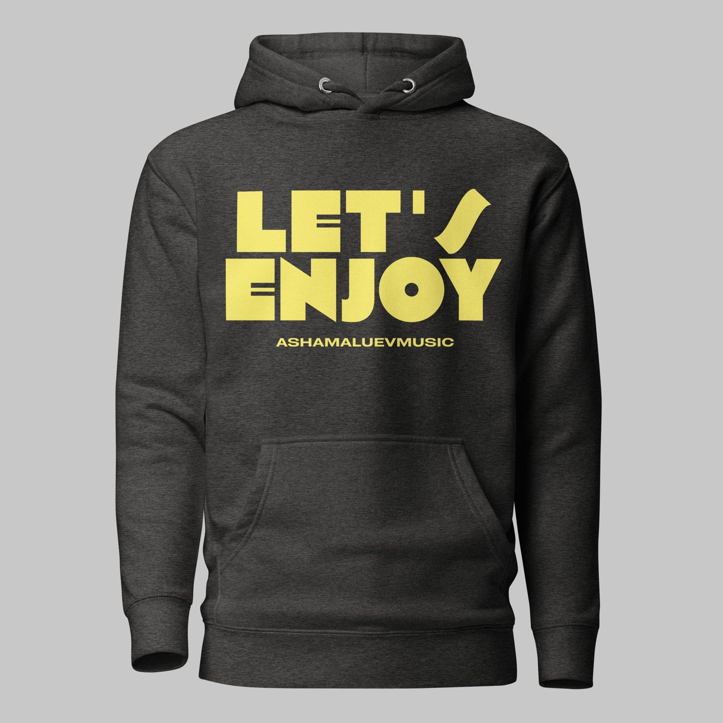 Charcoal heather unisex pullover hoodie with yellow text 'LET'S ENJOY' and 'ASHAMALUEVMUSIC' on a gray background.