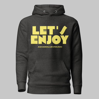 Charcoal heather unisex pullover hoodie with yellow text 'LET'S ENJOY' and 'ASHAMALUEVMUSIC' on a gray background.