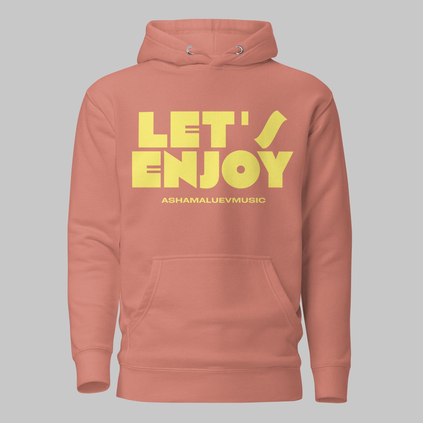 Dusty rose unisex pullover hoodie with yellow text 'LET'S ENJOY' and 'ASHAMALUEVMUSIC' on a gray background.