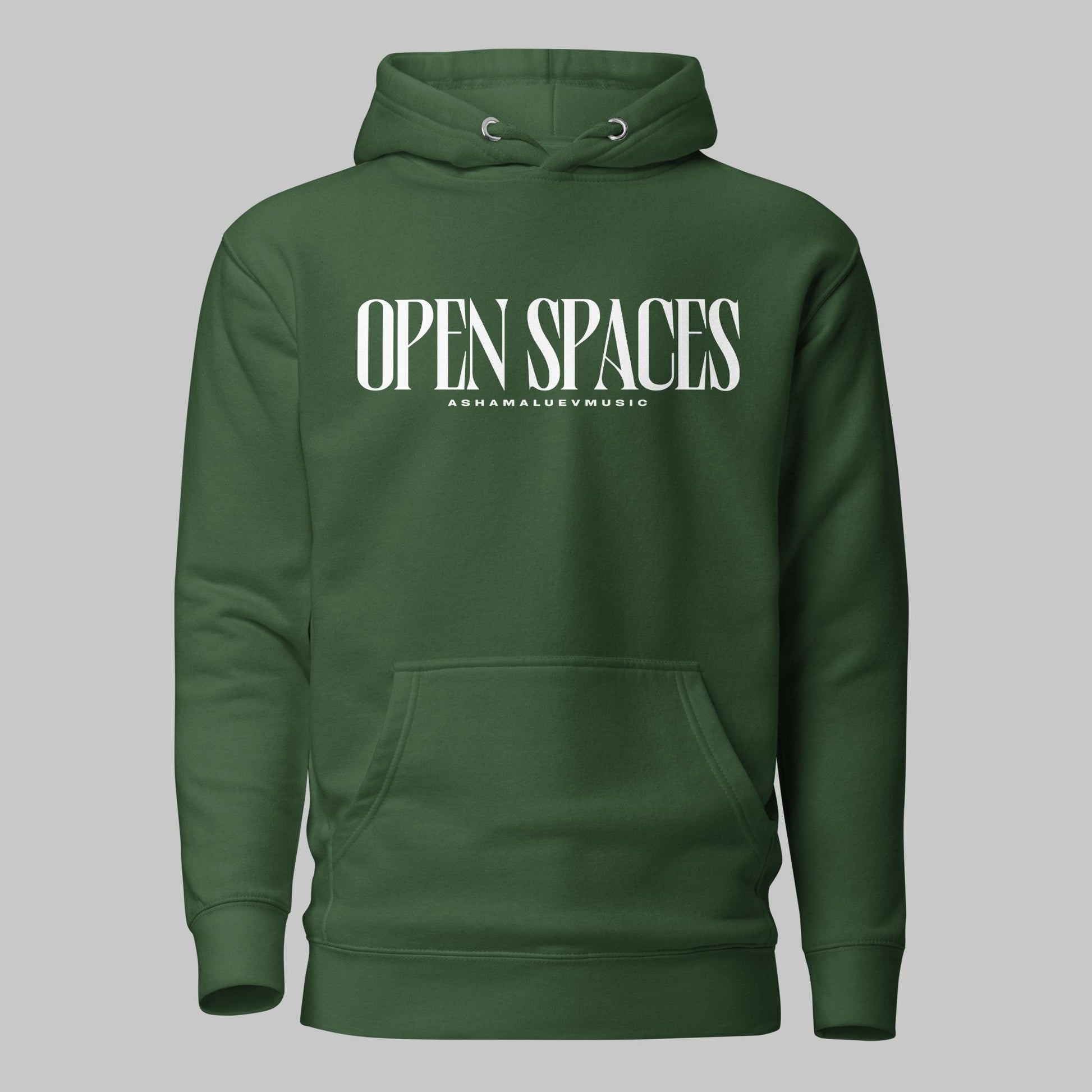 Forest green unisex pullover premium hoodie with white text 'OPEN SPACES' and 'AShamaluevMusic' on a gray background.