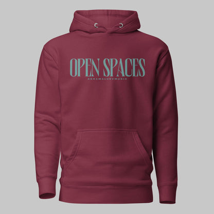 Maroon unisex premium hoodie with turquoise text 'Open Spaces' and 'AShamaluevMusic' on a gray background