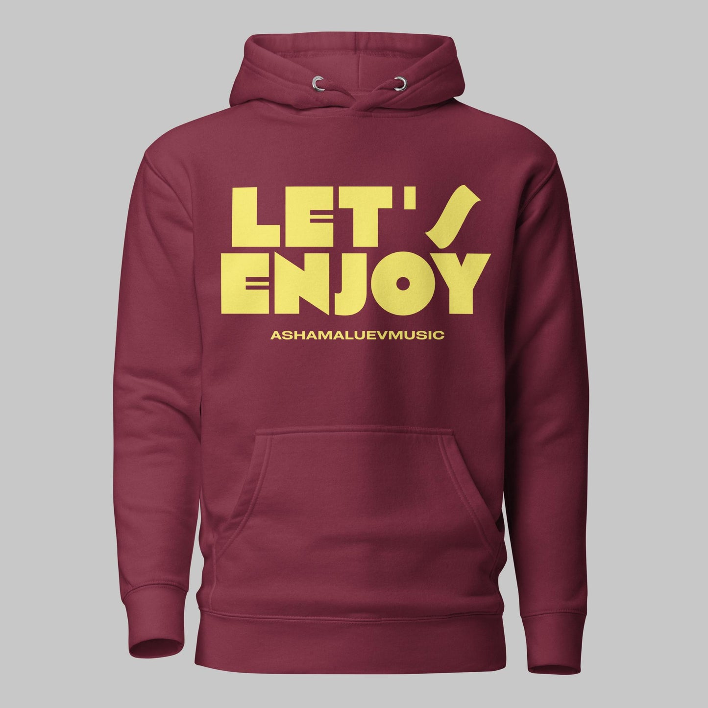 Maroon unisex pullover hoodie with yellow text 'LET'S ENJOY' and 'ASHAMALUEVMUSIC' on a gray background.