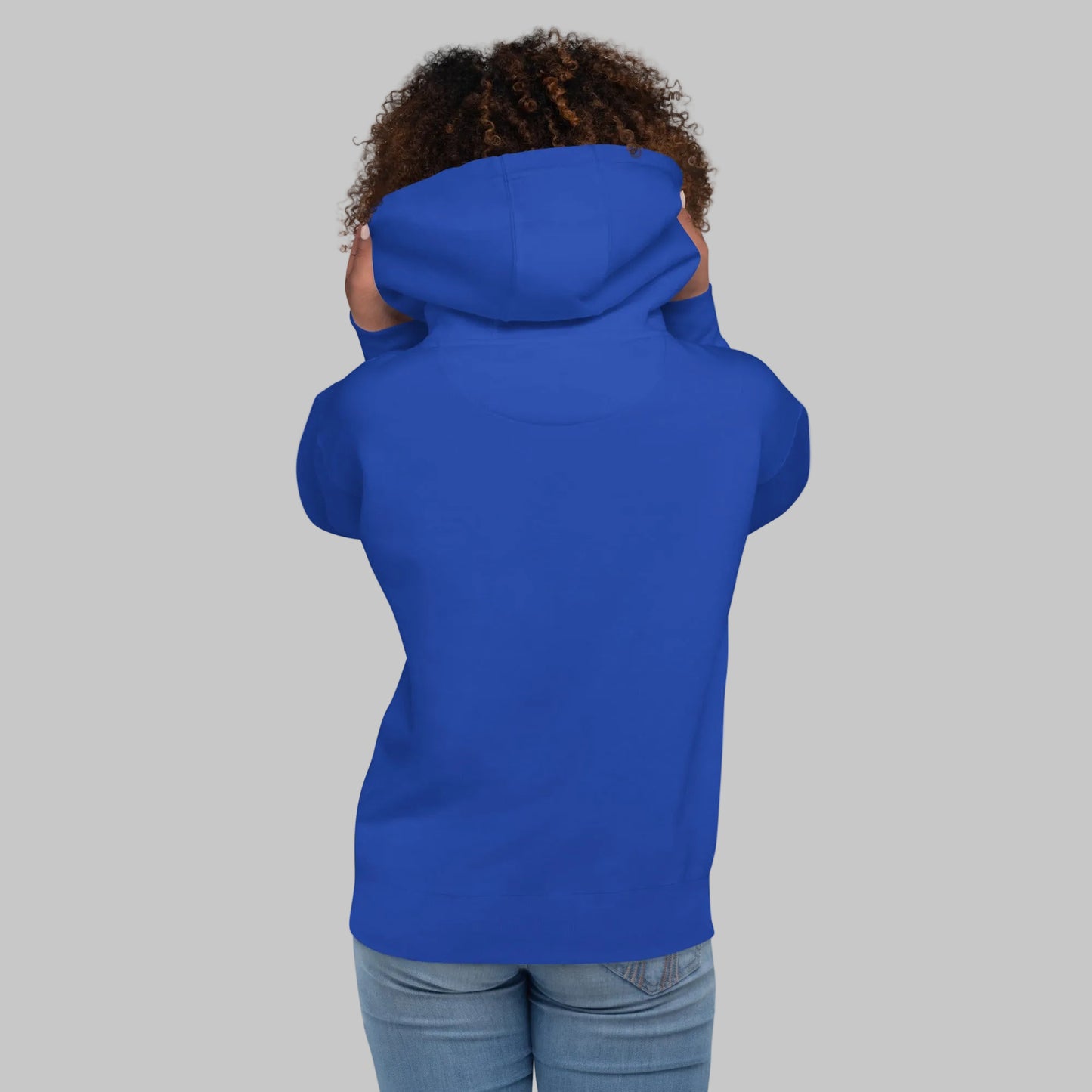 Woman wearing a blue hoodie from behind on a white background
