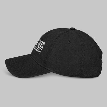 Black denim cap with white text 'Open Spaces' and 'AShamaluevMusic' on a gray background