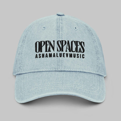 Light blue denim cap with black text 'Open Spaces' and 'AShamaluevMusic' on a gray background