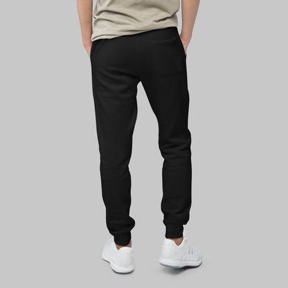 Man wearing black fleece sweatpants on a gray background