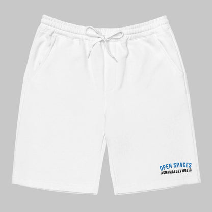 White men's fleece shorts with 'Open Spaces' and 'AShamaluevMusic' text on a gray background