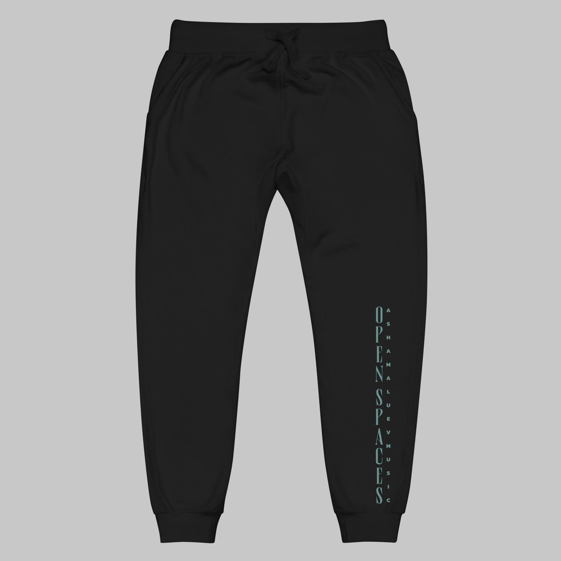Black unisex fleece sweatpants with turquoise text 'Open Spaces' and 'AShamaluevMusic' on a gray background.