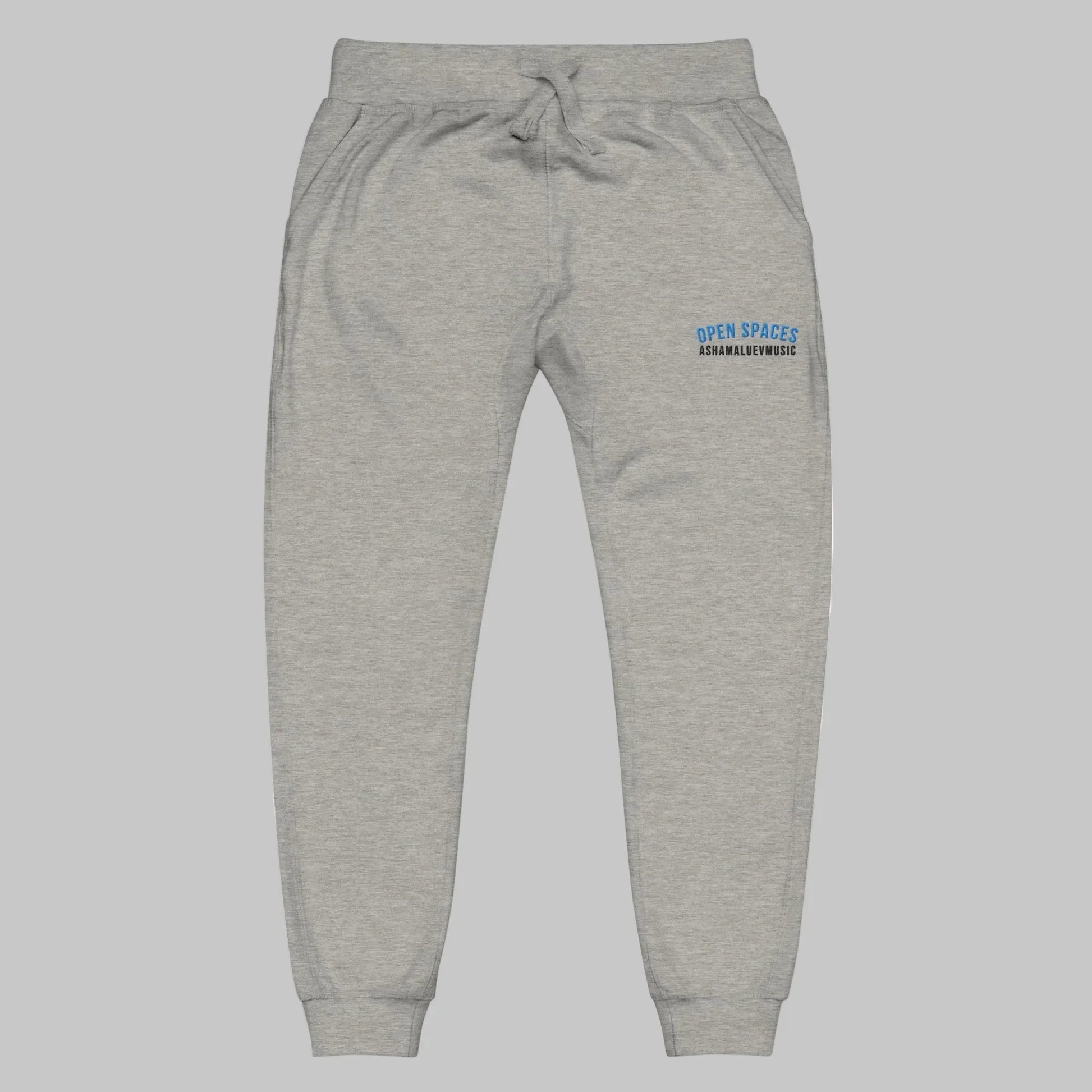 Grey sweatpants with 'Open Spaces' and 'AShamaluevMusic' embroidered on a grey background