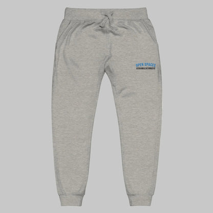 Grey sweatpants with 'Open Spaces' and 'AShamaluevMusic' embroidered on a grey background