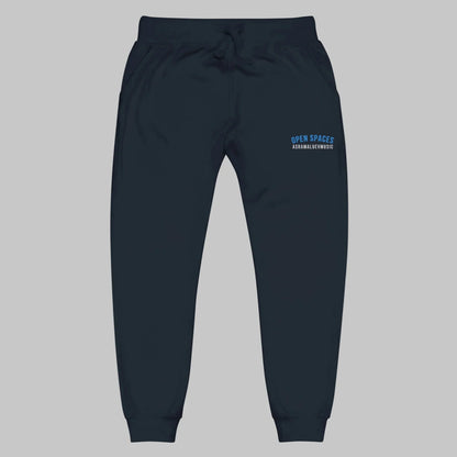 Navy sweatpants with 'Open Spaces' and 'AShamaluevMusic' embroidered on a gray background