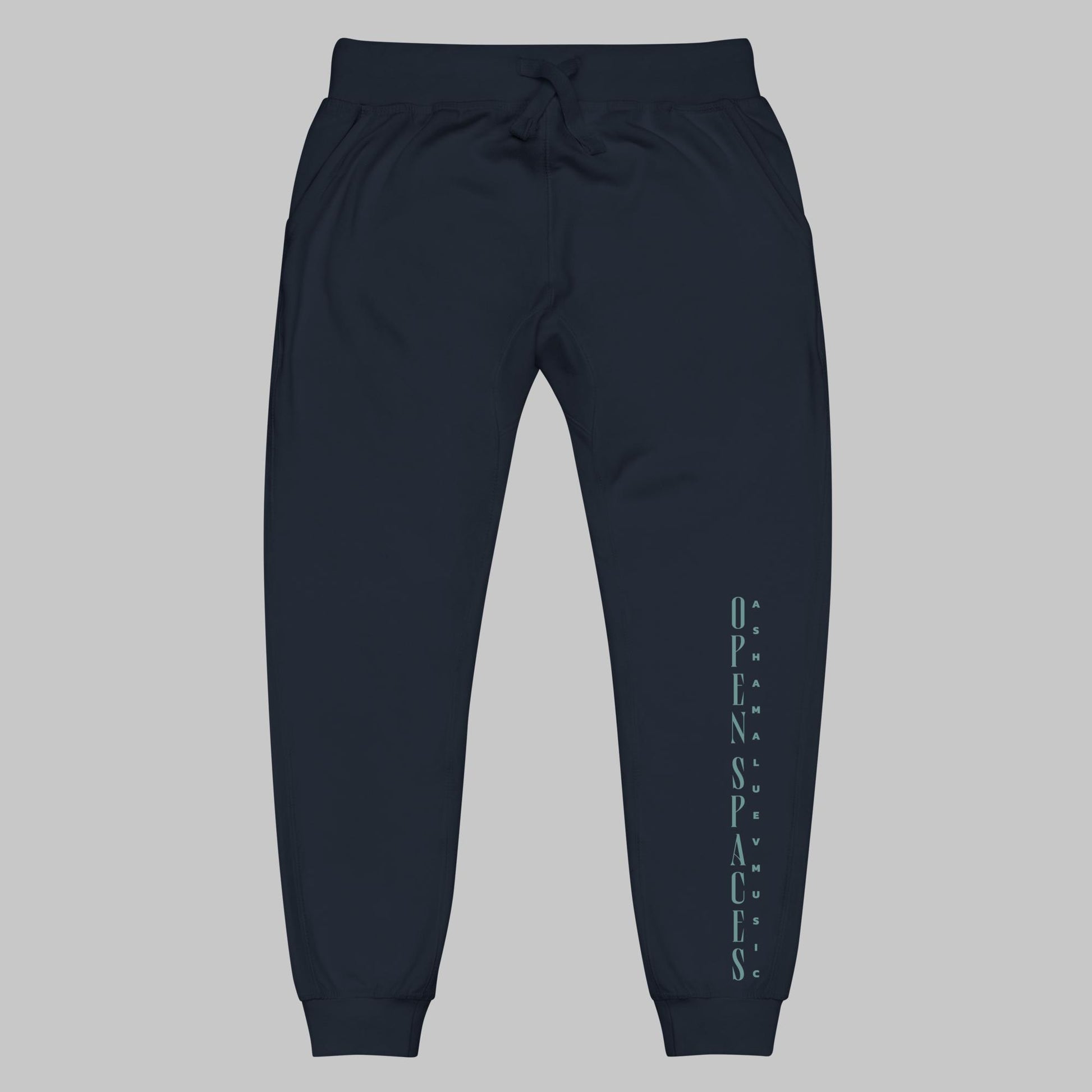 Navy blazer unisex fleece sweatpants with turquoise text 'Open Spaces' and 'AShamaluevMusic' on a gray background.