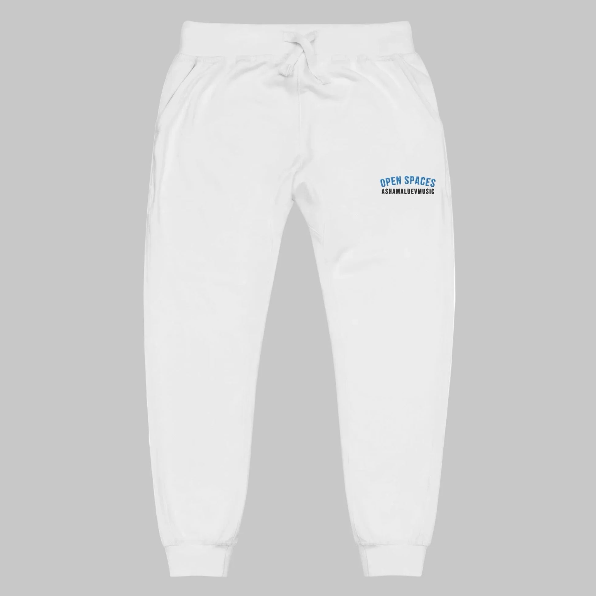 White sweatpants with 'Open Spaces' and 'AShamaluevMusic' embroidered on a grey background