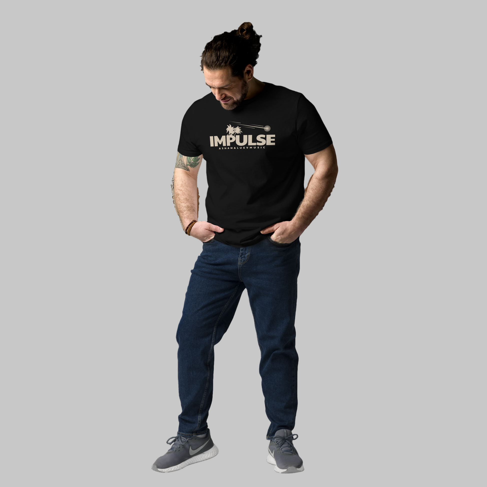 Man wearing a black t-shirt with 'IMPULSE' logo on a grey background