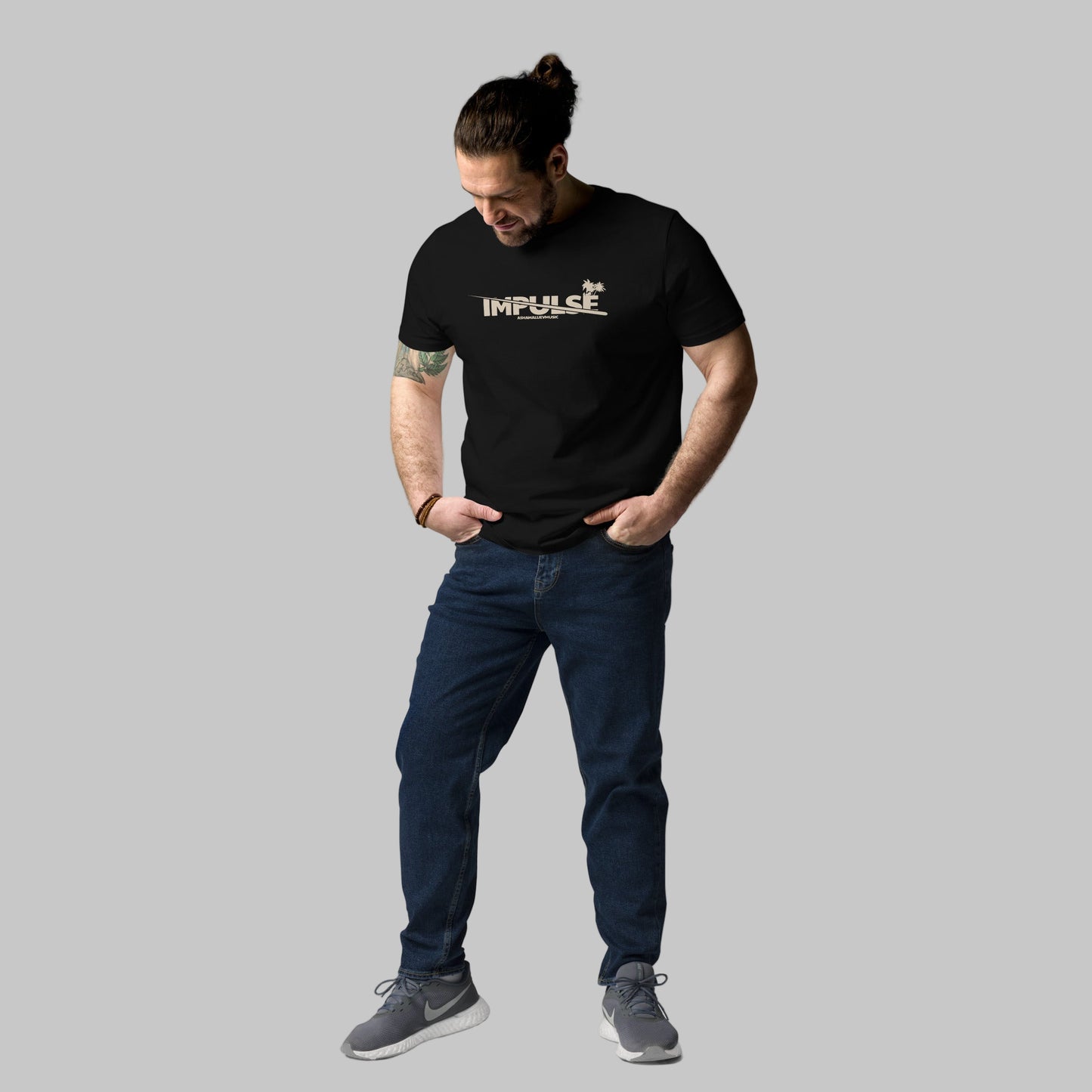 Man wearing a black t-shirt with text 'IMPULSE' and AShamaluevMusic logo on a grey background