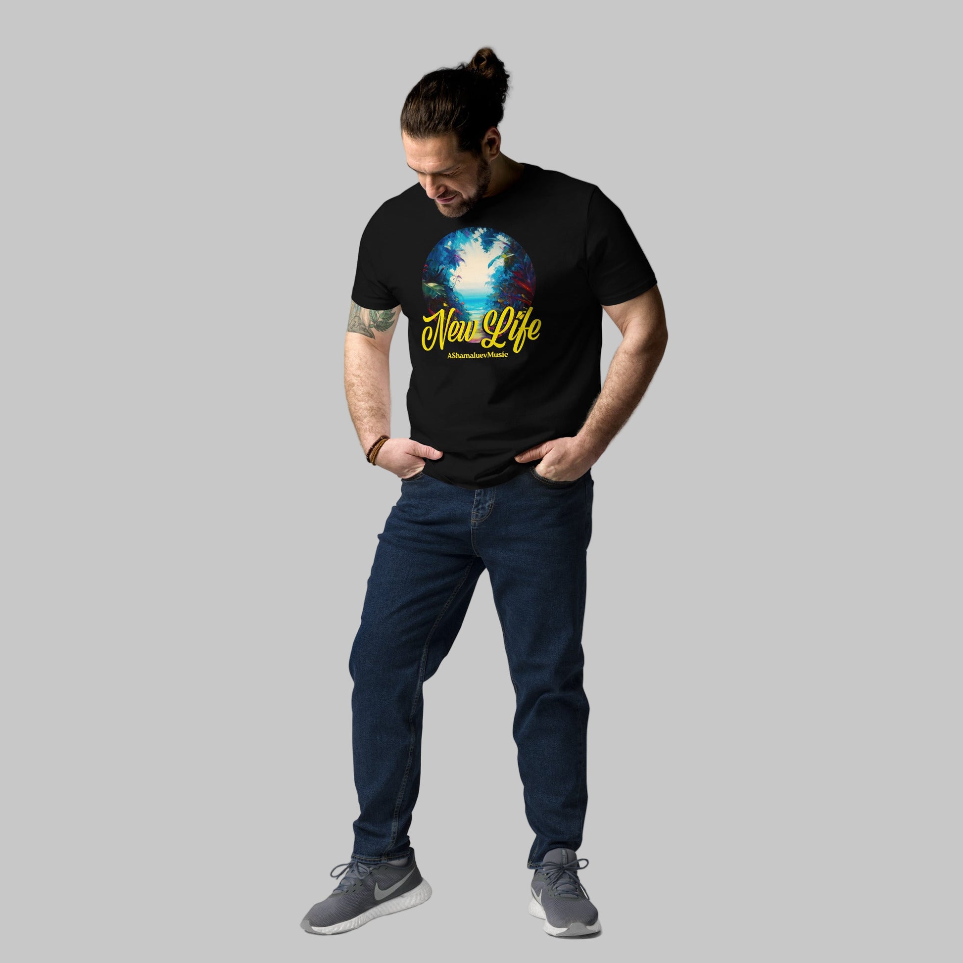 Man wearing a black organic cotton t-shirt with 'New Life' print and AShamaluevMusic logo on a light grey background