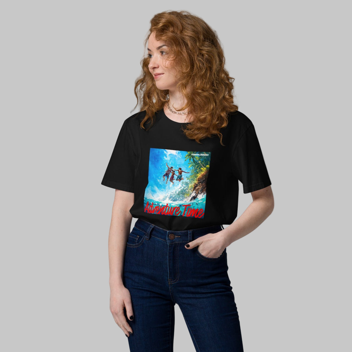 Woman wearing a black t-shirt with a 'Adventure Time' graphic design and AShamaluevMusic logo on a grey background.