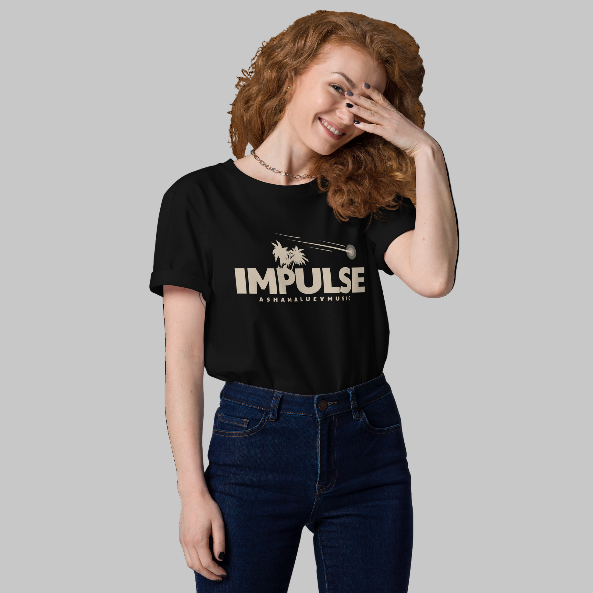 Woman wearing a black t-shirt with 'IMPULSE' and AShamaluevMusic logo on a grey background