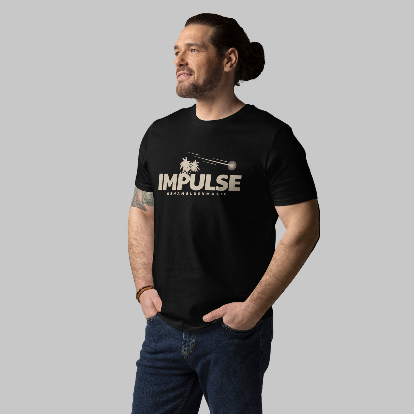 Man wearing a black t-shirt with 'IMPULSE' logo on a grey background