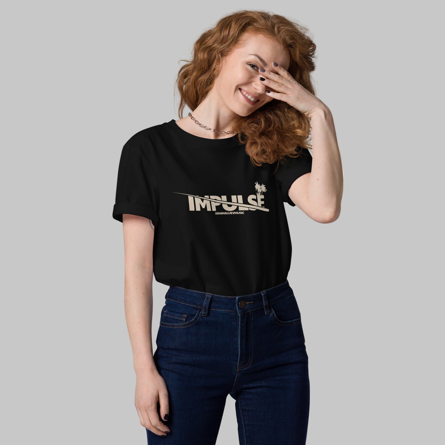 Woman wearing a black t-shirt with text 'IMPULSE' and AShamaluevMusic logo on a grey background