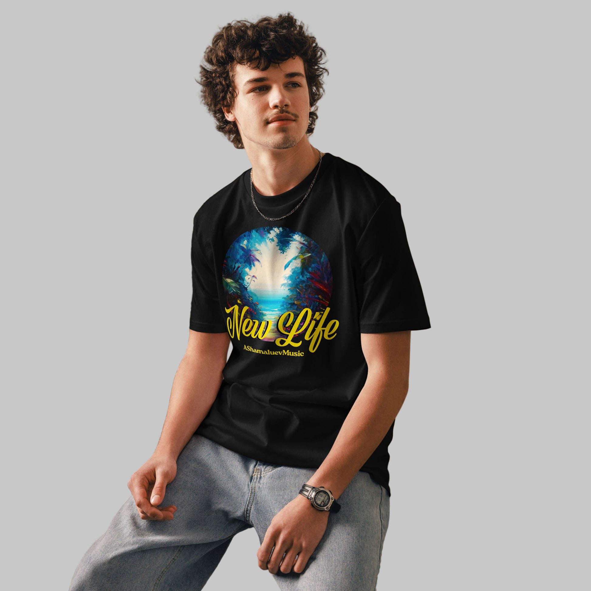 Man wearing a black organic cotton t-shirt with 'New Life' print and AShamaluevMusic logo on a light grey background