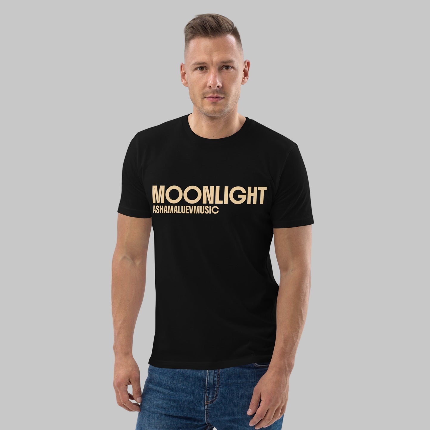 Man wearing a black organic cotton t-shirt with 'Moonlight' print and AShamaluevMusic logo on a light grey background