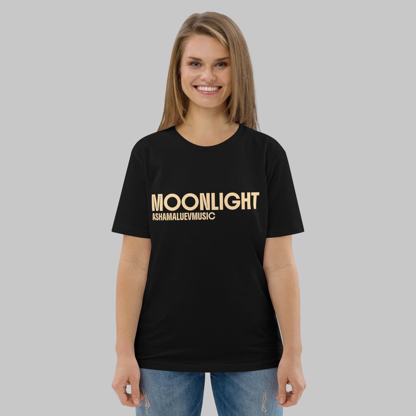 Woman wearing a black organic cotton t-shirt with 'Moonlight' print and AShamaluevMusic logo on a light grey background