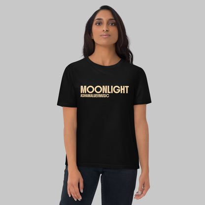 Woman wearing a black organic cotton t-shirt with 'Moonlight' print and AShamaluevMusic logo on a light grey background