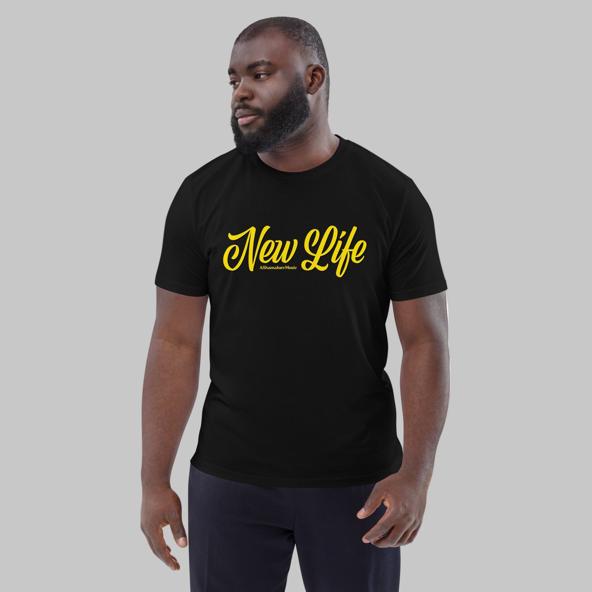 Man wearing a black organic cotton t-shirt with 'New Life' print and AShamaluevMusic logo in yellow text on a grey background