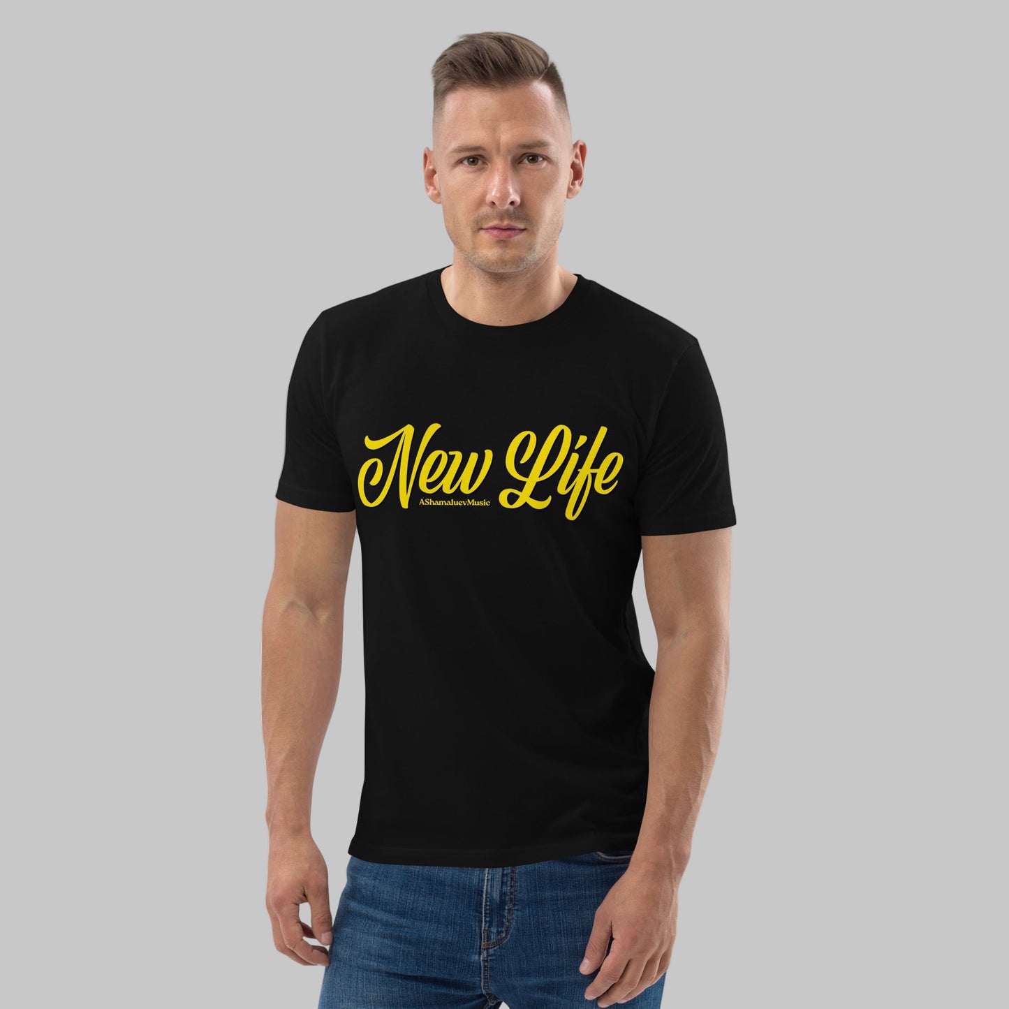 Man wearing a black organic cotton t-shirt with 'New Life' print and AShamaluevMusic logo in yellow text on a grey background