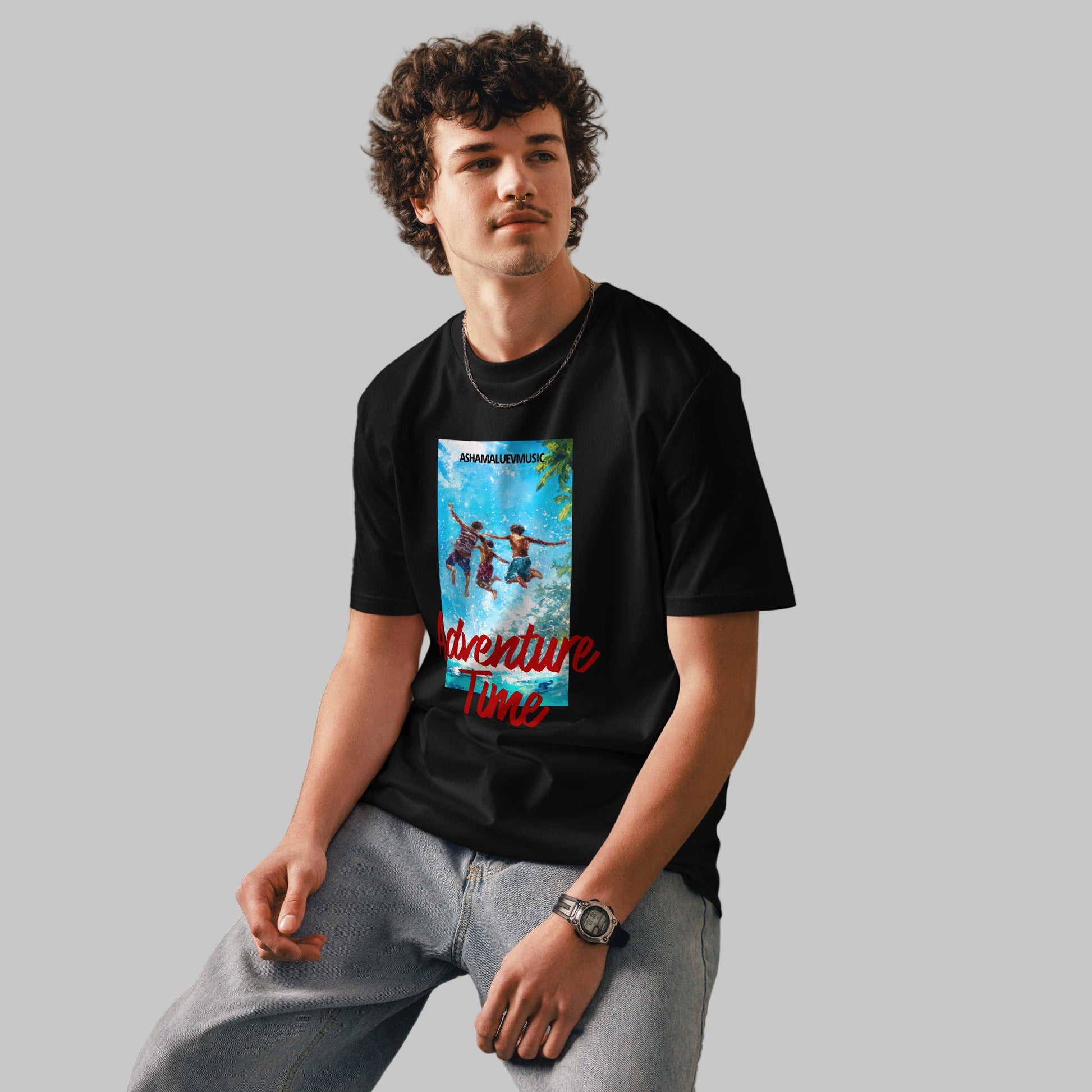 Man wearing a black t-shirt with 'Adventure Time' graphic design and AShamaluevMusic logo on a grey background.